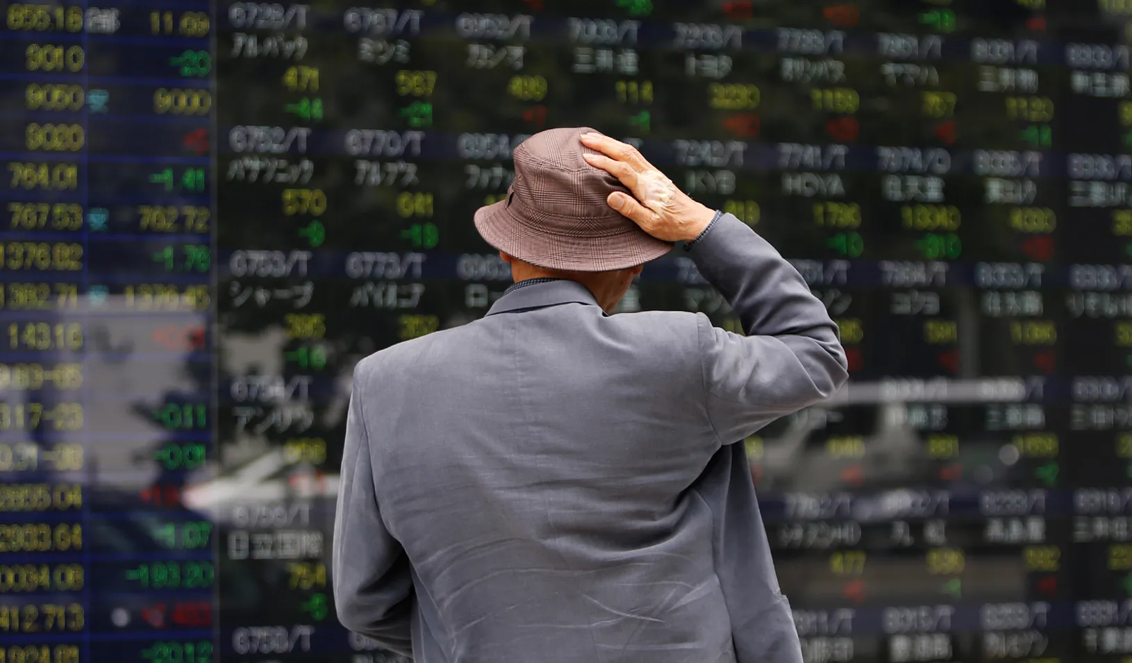 A man looks at a stock quotation board outside a brokerage. Credit: Reuters/Toru Hanai