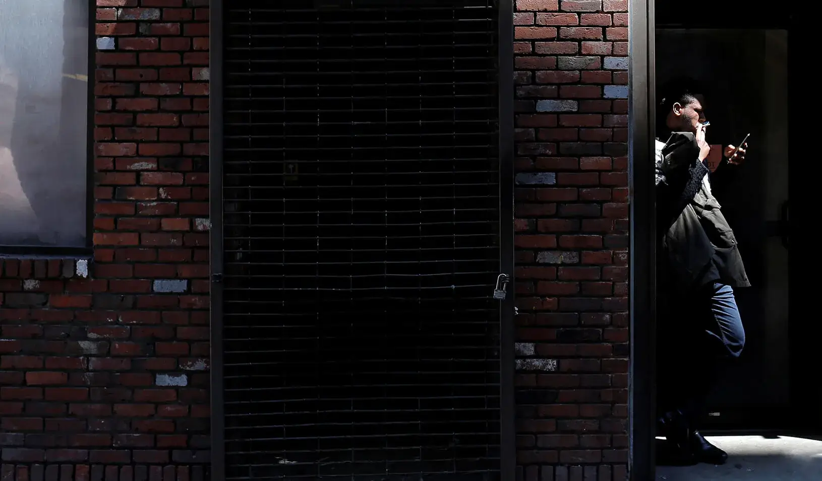 A man smokes a cigarette in a doorway in downtown Boston, Massachusetts. | Reuters/Brian Snyder