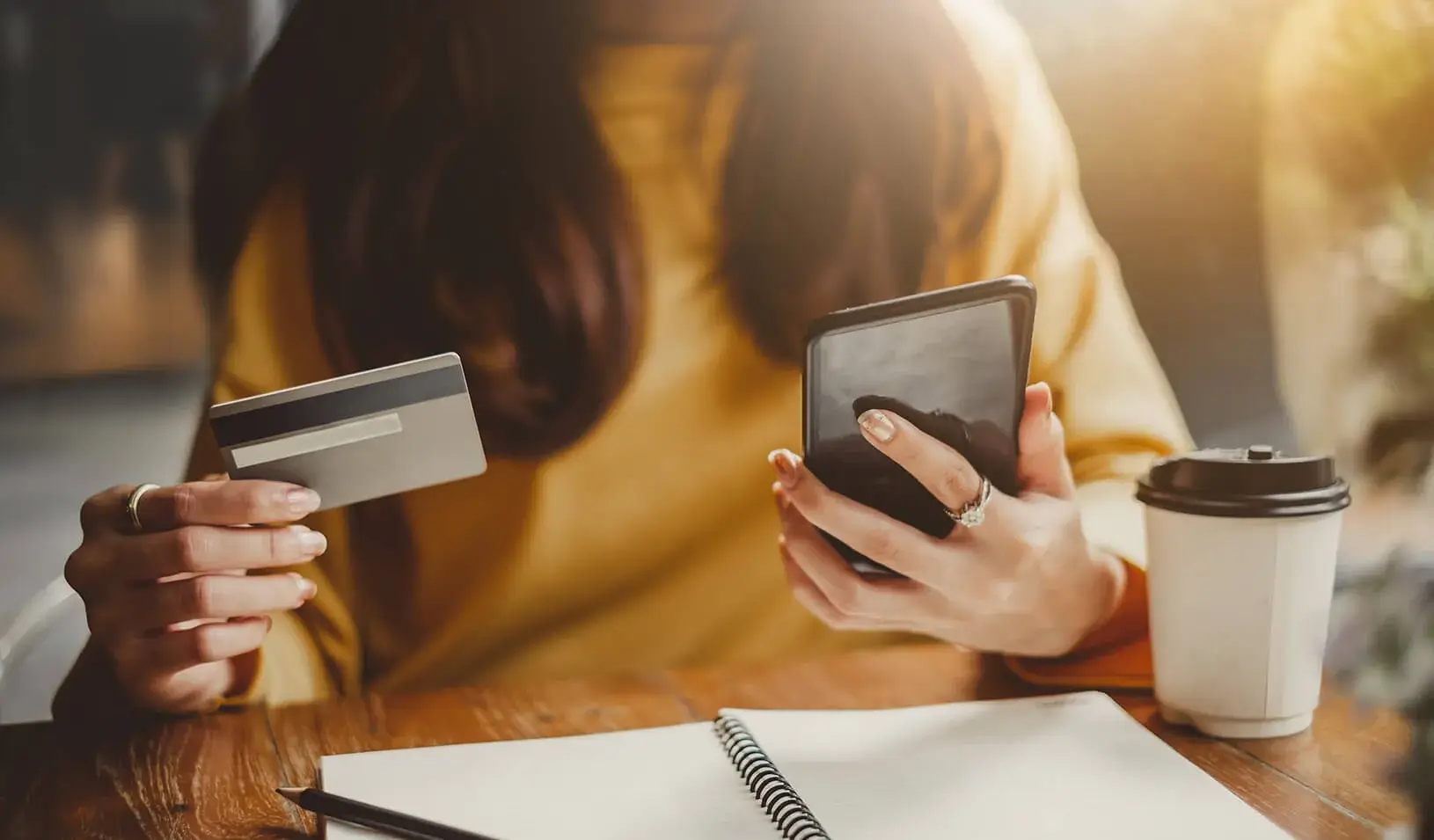 A woman uses her credit card to shop on her smartphone. Credit: iStock/Nattakorn Maneerat