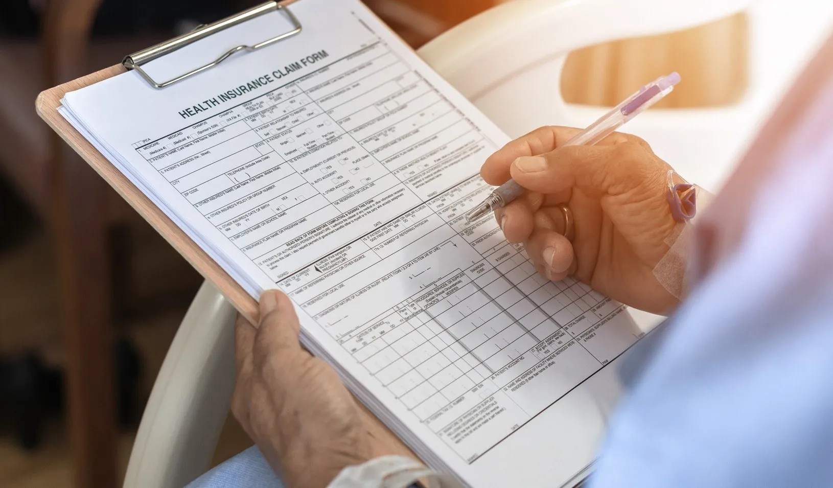 Health insurance claim form application for patient with illness in hospital ward. Credit: iStock/Chinnapong