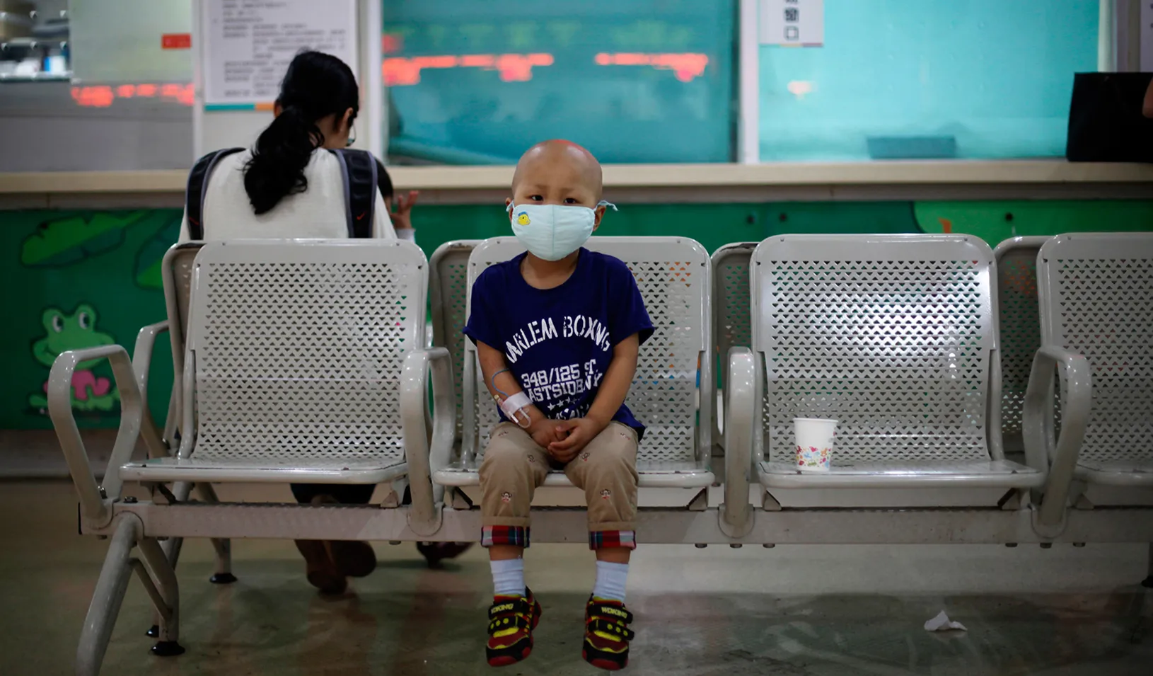 Little boy sitting in a hospital waiting room in Shanghai
