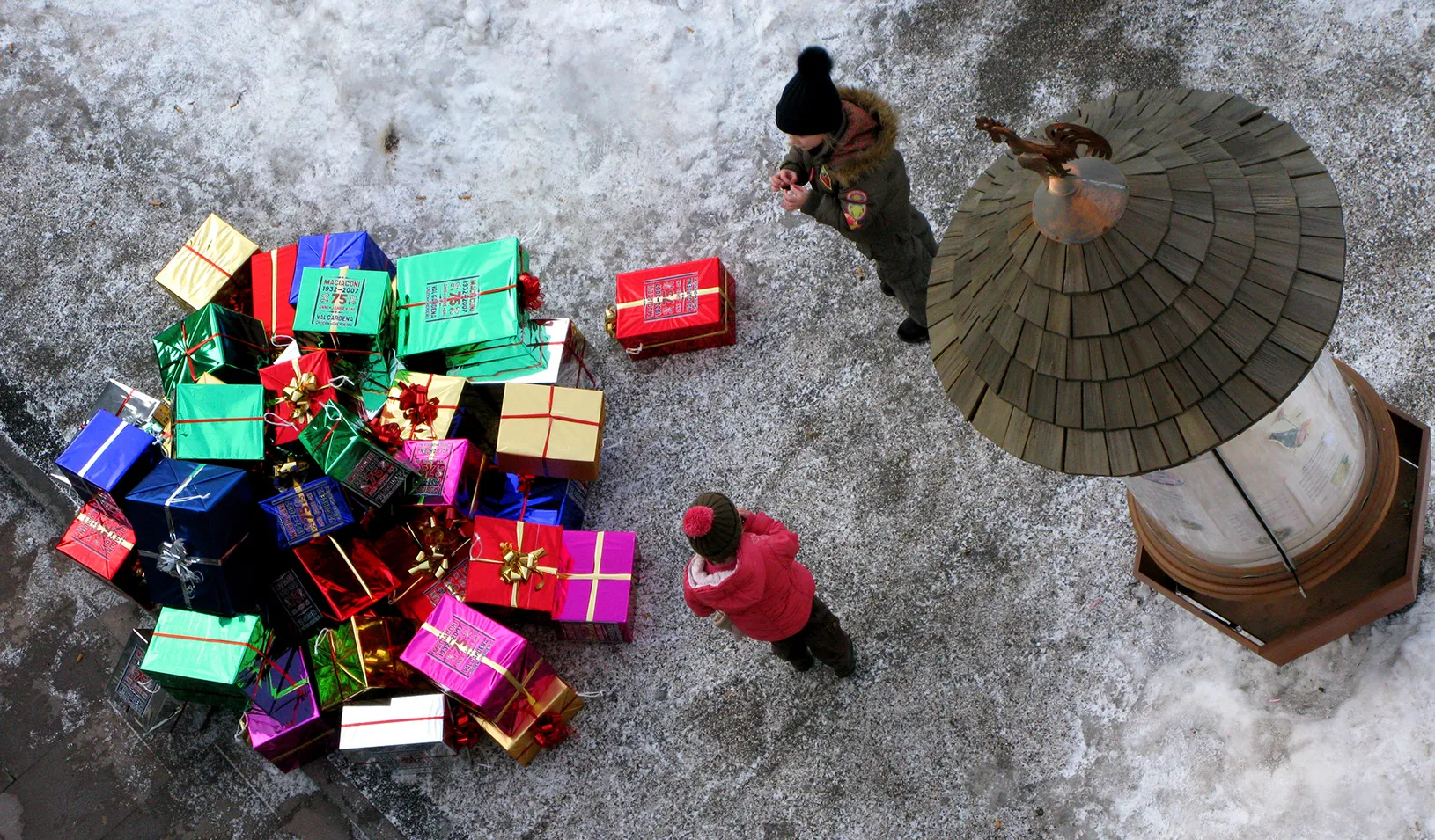 Children next to a pile of gifts
