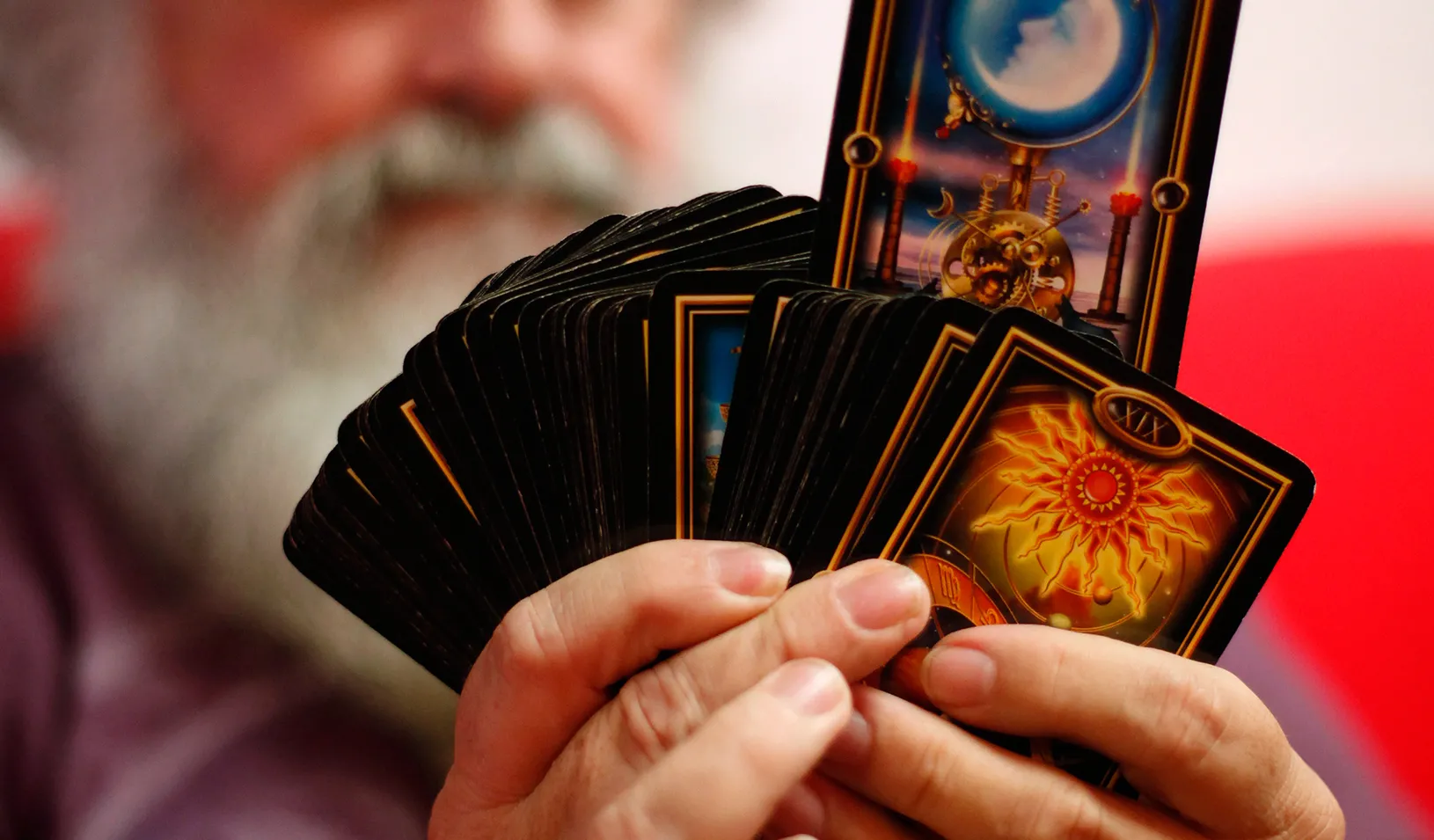 A man holding a deck of magic cards