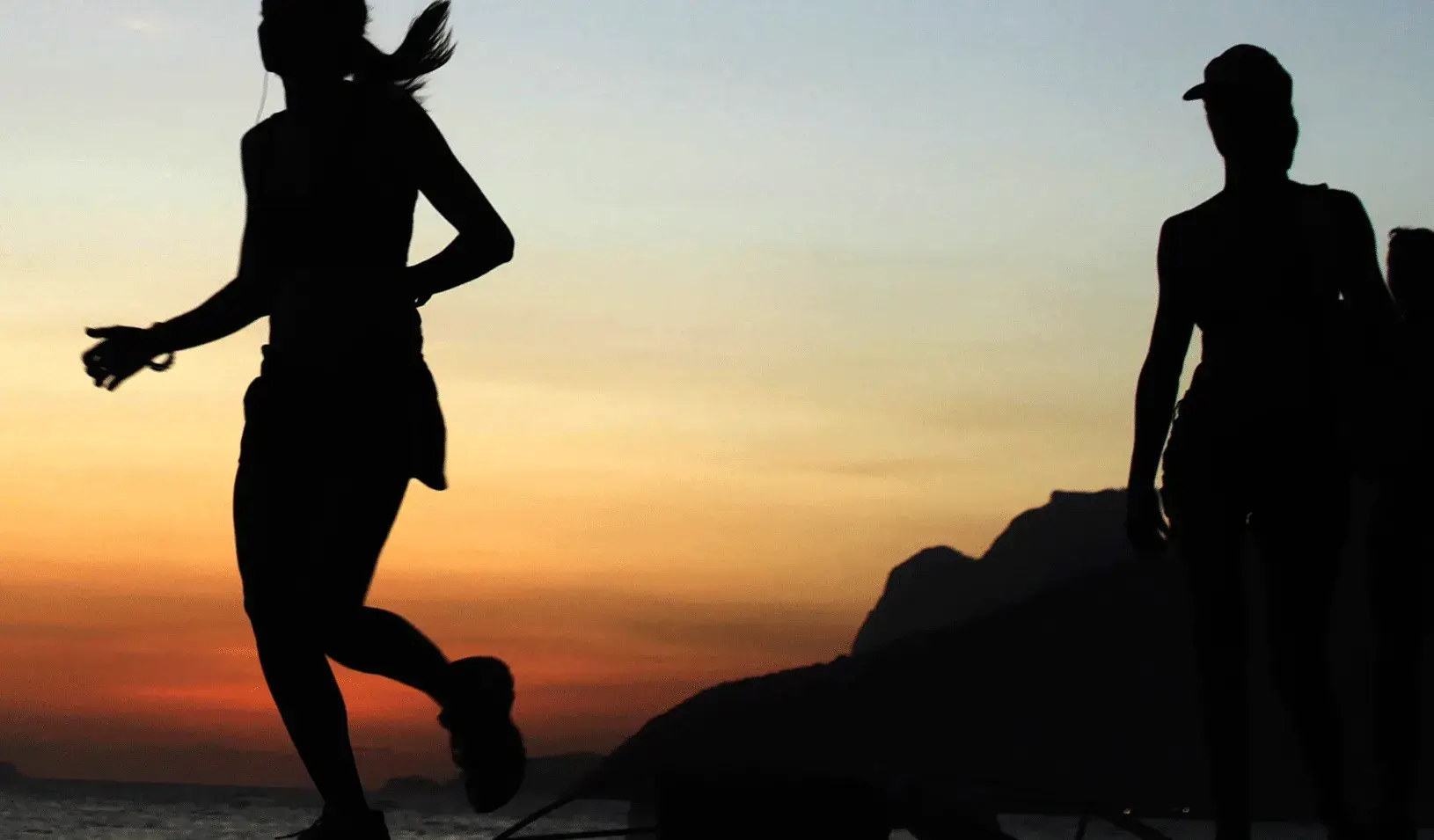 A woman running at sunset.