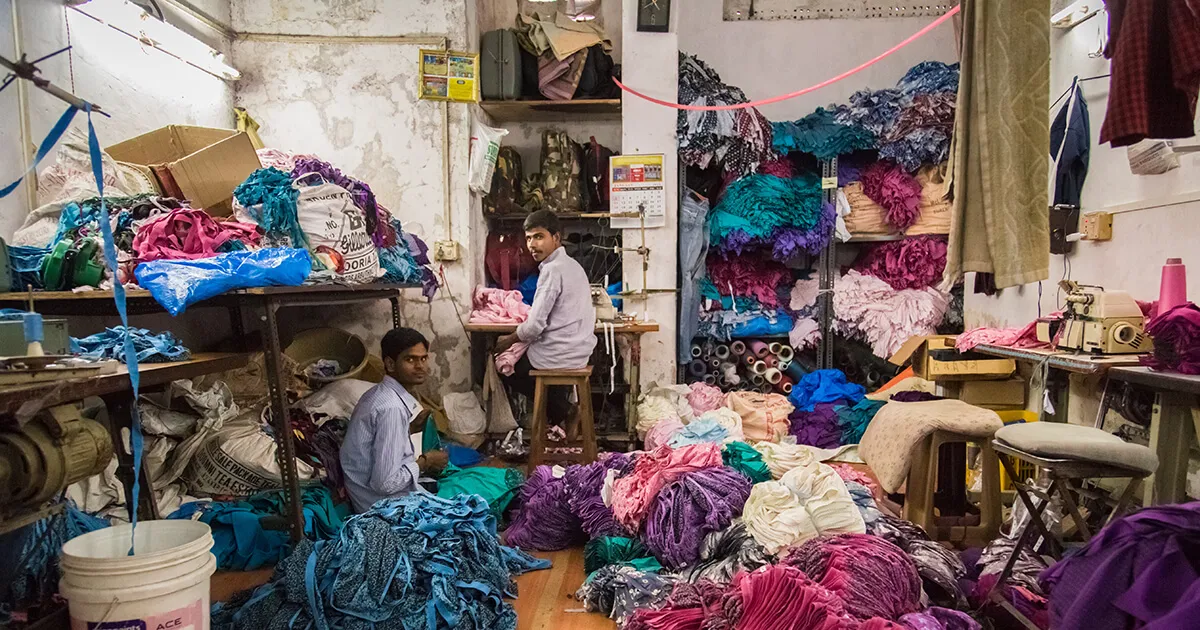 Two men work in small underwear factory in Dharavi slum