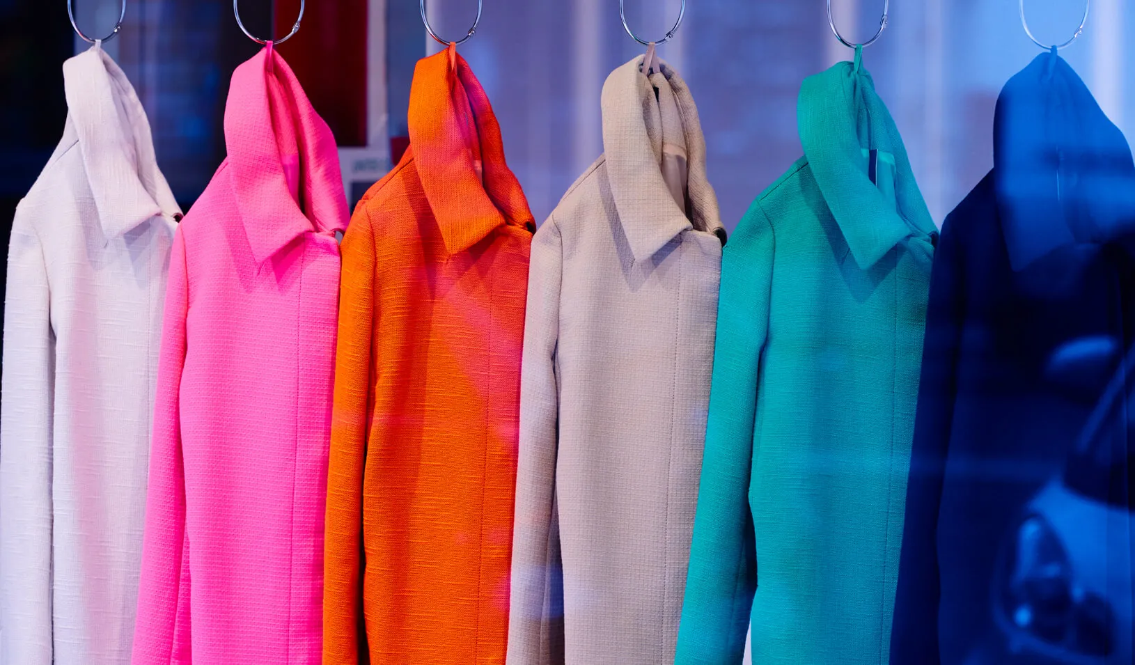 A rack of brightly colored coats. Credit: iStock/stock_colors