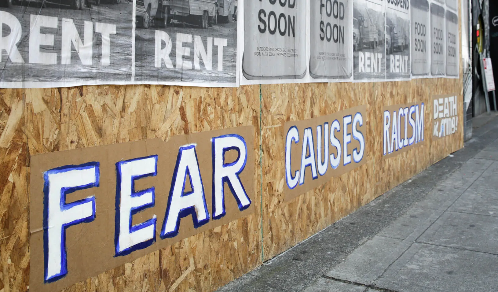 Signs that read “suspend rent” and “fear causes racism” are pictured on a boarded-up business in Seattle during the outbreak of the coronavirus disease (COVID-19). Credit: Reuters/Jason Redmond