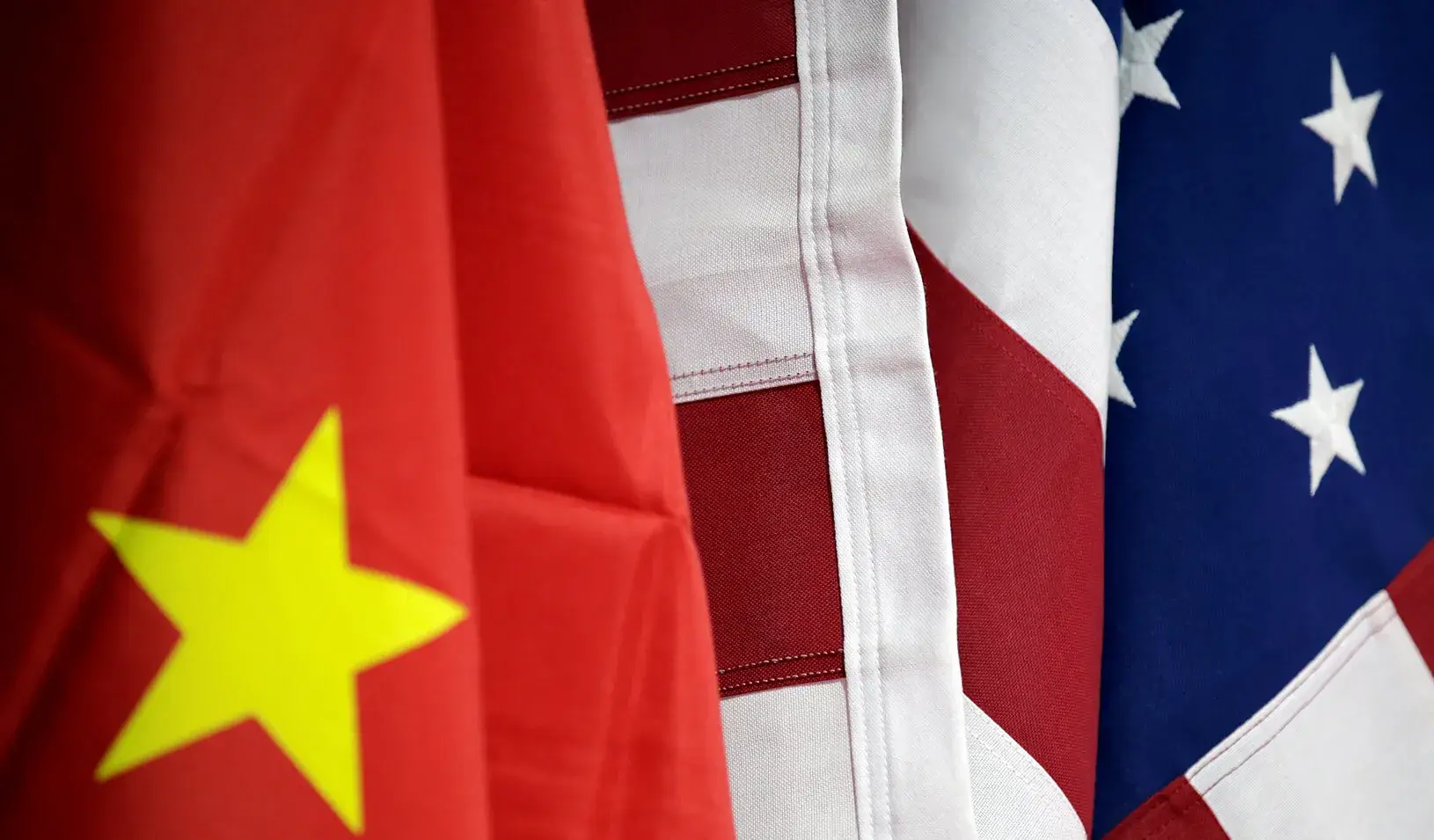 Flags of U.S. and China are displayed. Credits: Reuters/Jason Lee