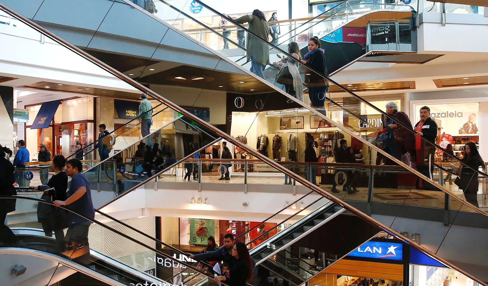 People ride escalators inside a shopping mall. | Reuters/Rodrigo Garrido