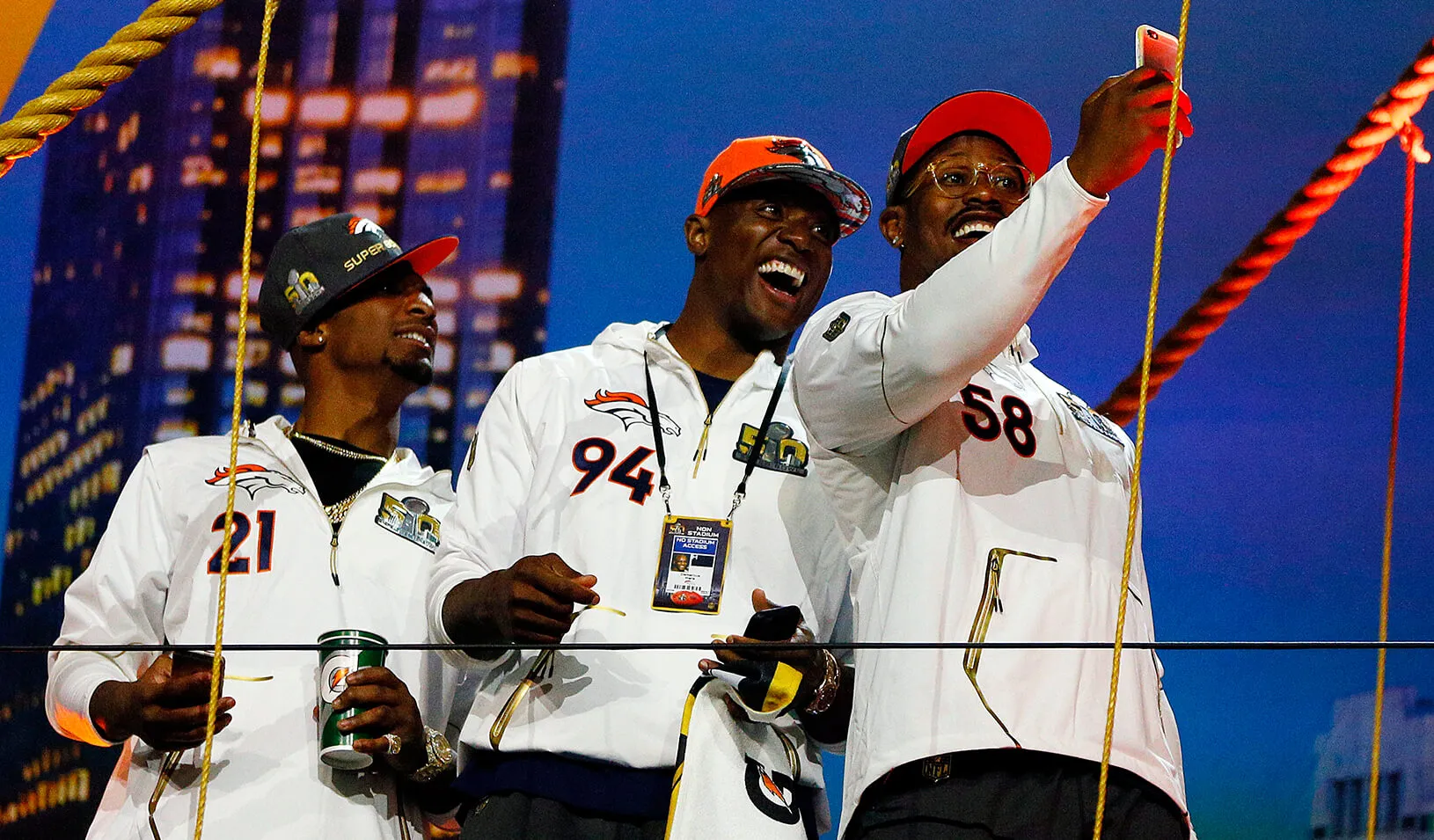 Three Denver Bronco players take a selfie during Super Bowl 50 Opening Night media day.