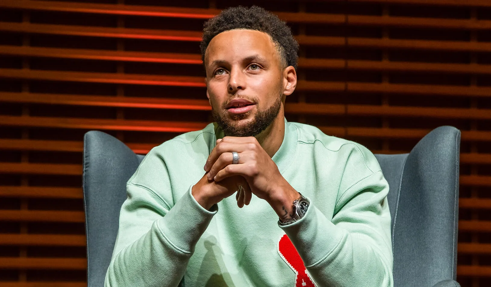 Close up shot of Wardell Stephen Curry sitting and holding his hands, looking off camera. Credit: Stacy Geiken
