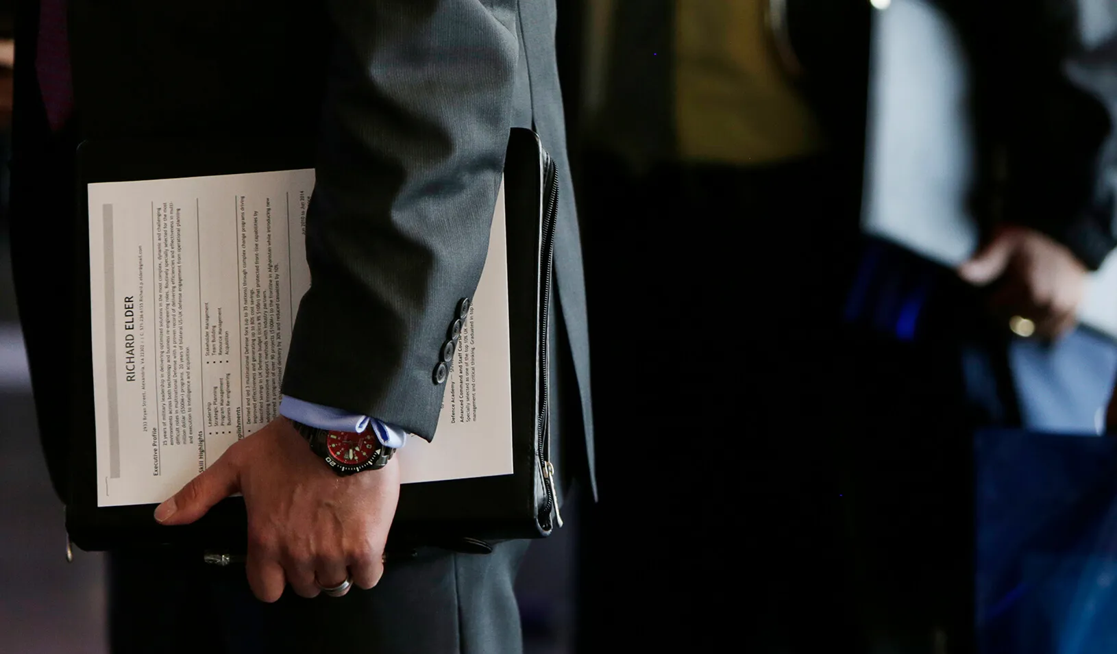 An applicant holds his resume at a hiring fair for job seekers