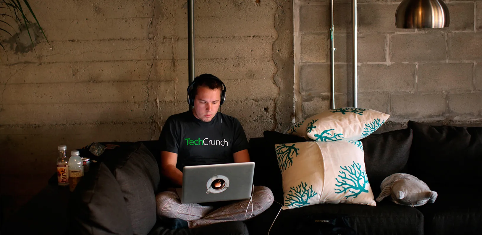 Engineer Buford Taylor sits on a couch as he works on his computer at Eventbrite headquarters in the South of Market area in San Francisco, California