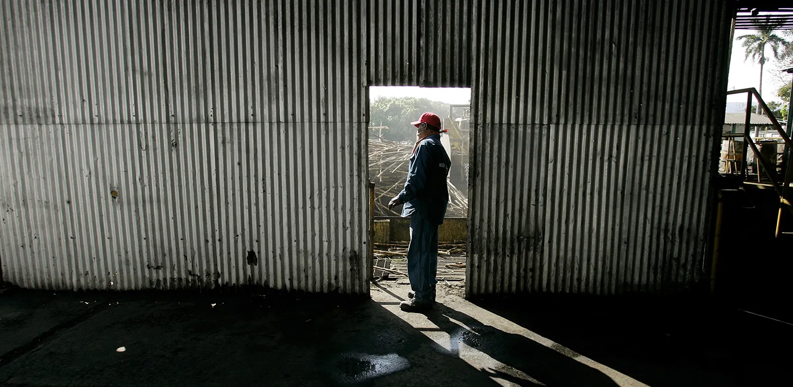 Man standing in doorway of rundown building