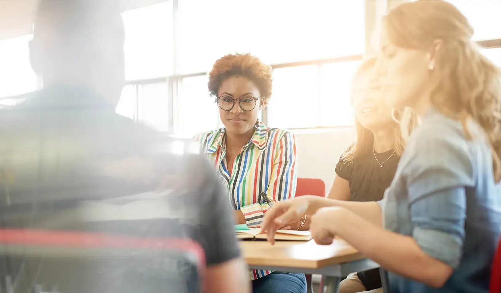 Creative business people in meeting. | iStock/julief514