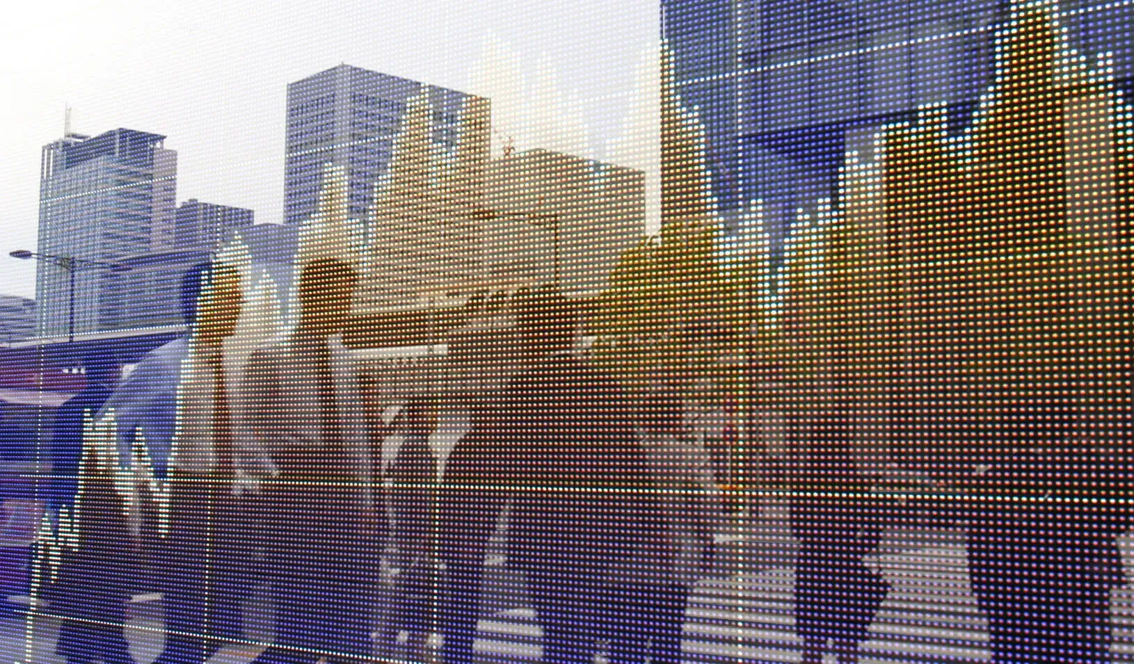 Pedestrians are reflected on an electronic board showing a graph of market data | Reuters/Yuriko Naka