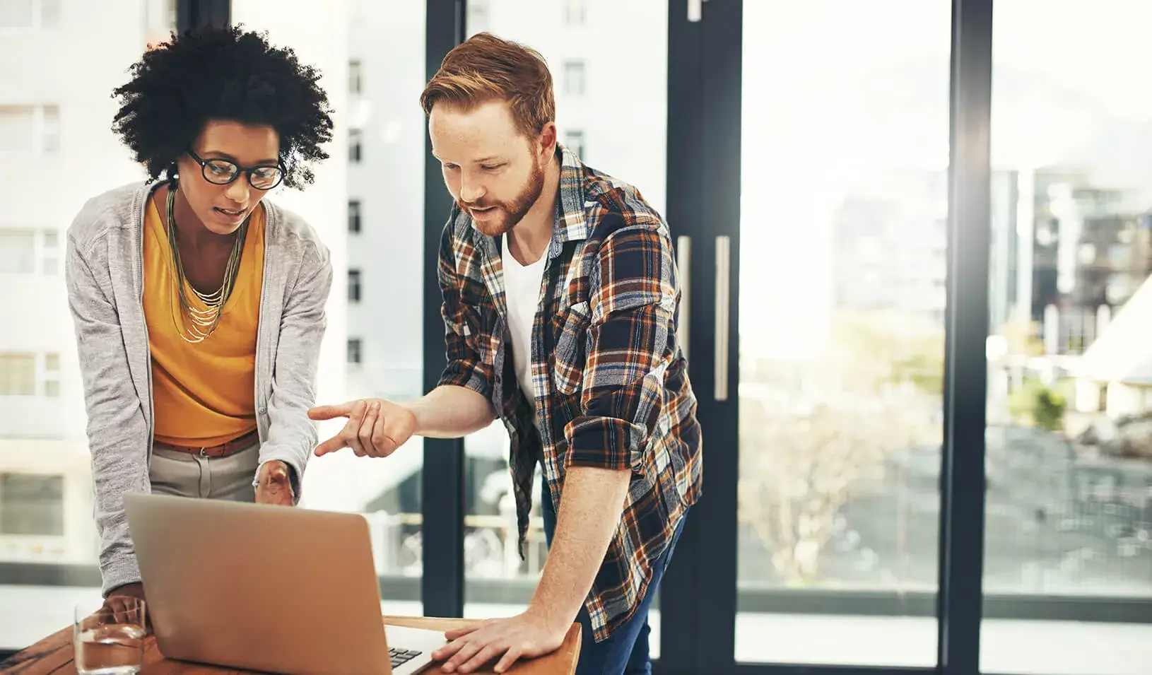 two young people working |  iStock/mapodile