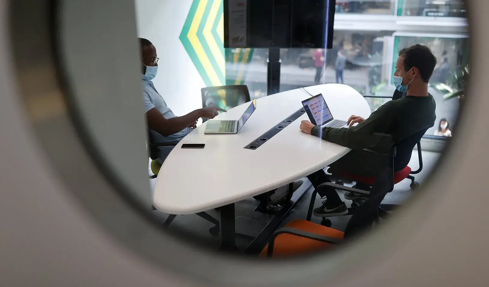People wearing face masks are seen at work at the “Station F”, a mega-campus for startups. Reuters/Christian Hartmann