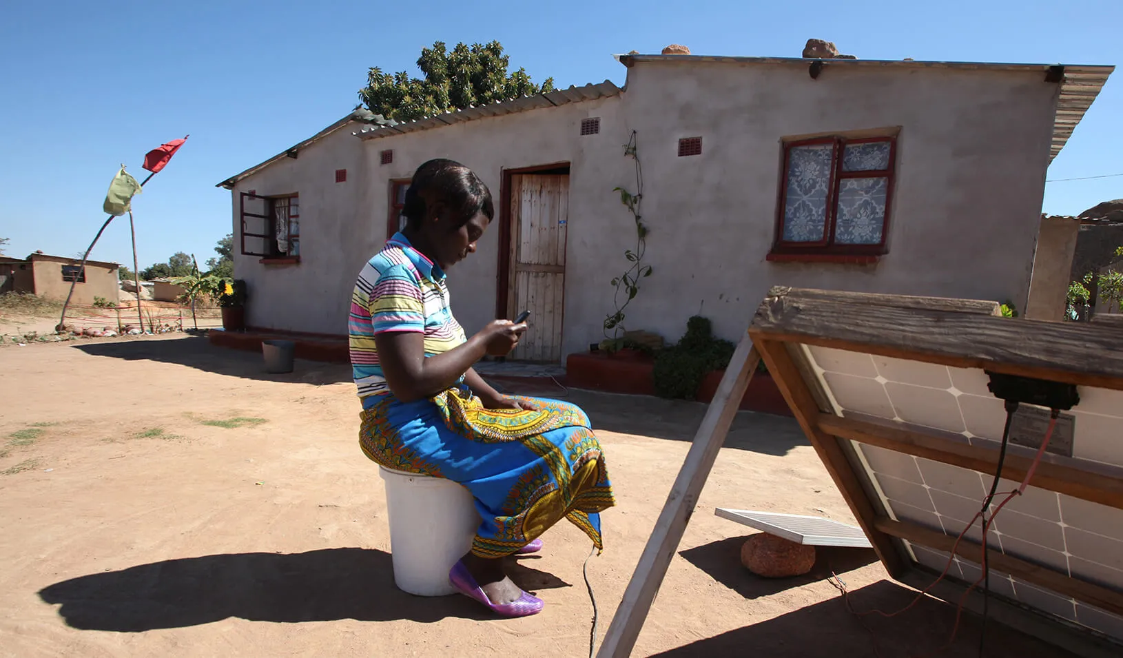 A women looks at her mobile phone in Zimbabwe. | Reuters/Philimon Bulawayo