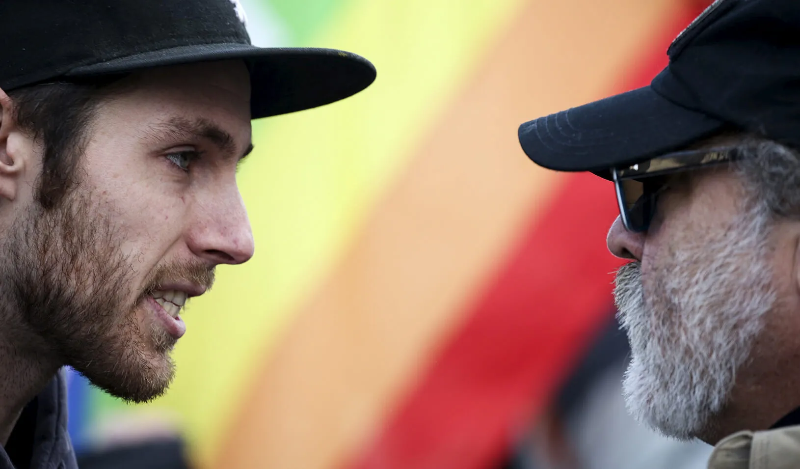 Counter-protester Sean Mullin speaks with protester Scott Bannister, of the Liberty For All group, as Bannister demonstrates against the United States’ acceptance of Syrian refugees at the Washington State Capitol in Olympia. Credit: Reuters/David Ryder
