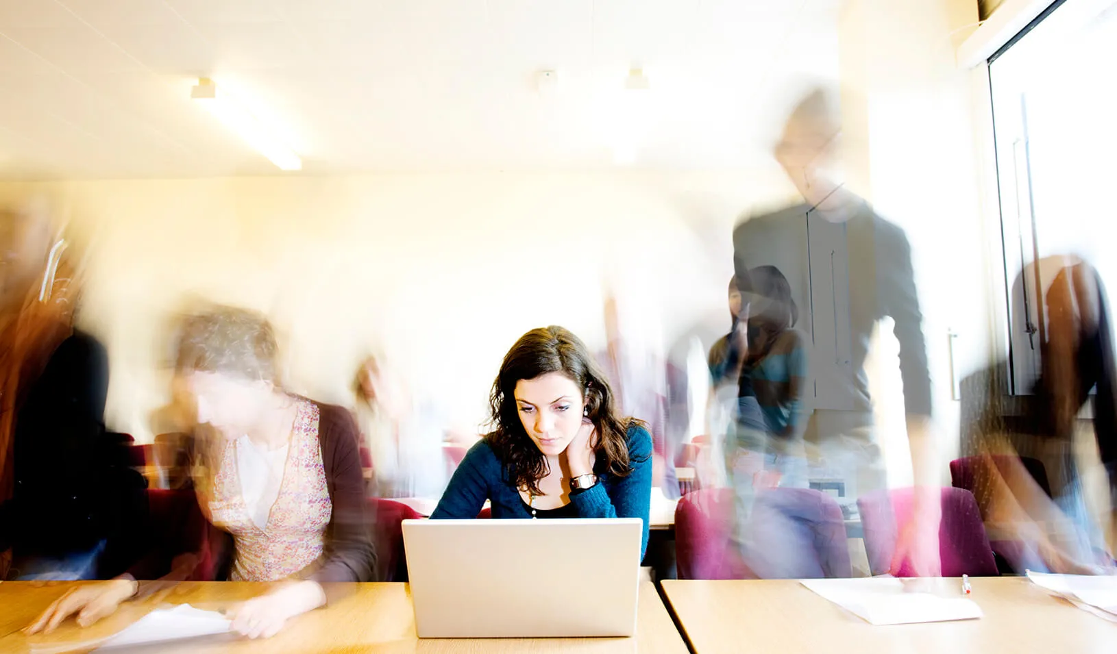 A student in front of her computer | iStock/Rene Mansi