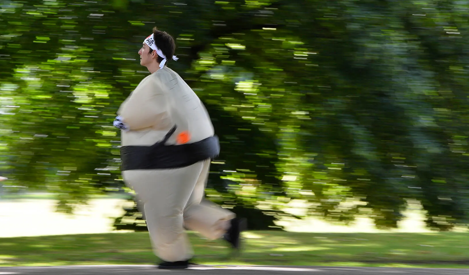 A runner dressed in an inflatable Sumo costume takes part in a 5k. | Reuters/Toby Melville