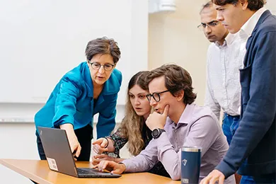 Stanford GSB faculty — such as Professor Susan Athey, shown here with Golub Lab students — students, and staff are making AI an integral part of programming across the school | Elena Zhukova