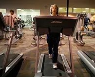 Elderly woman walking on a treadmill