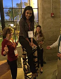 Volunteer sitting on a stool