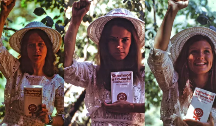 Three women stand with fists raised holding books. Credit: Photo courtesy of Luther Nussbaum