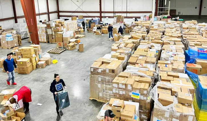 Students work in a warehouse preparing medical supplies to send to Ukraine. Credit: photo courtesy Kate Slunkova