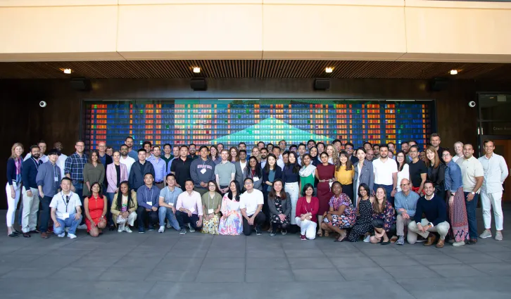 The MSx Class of 2023 standing in front of the change wall on Stanford GSB campus. Photo: Julia Yu