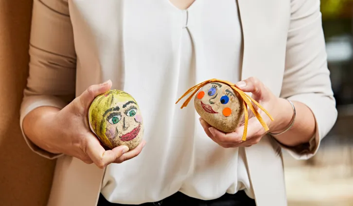 A photo of Ashley Martin holding her painted rocks. Credit: Photo by Gabriela Hasbun