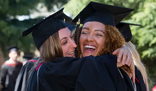 Graduates hugging