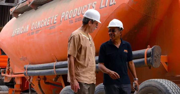 Two men consulting at an African country's construction site.