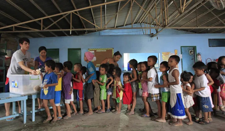 Children lining up for food. Credit: Reuters/Romeo Ranoco