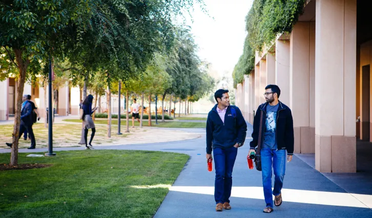 Two students walking on campus | Elena Zhukova 
