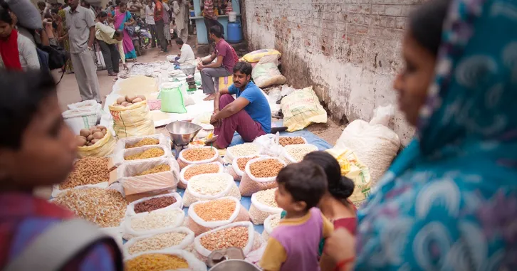 Indian vendors set up bags of grains and spices along the roadway in the outdoor spice market, located in the old part of the city. | iStock/BDphoto