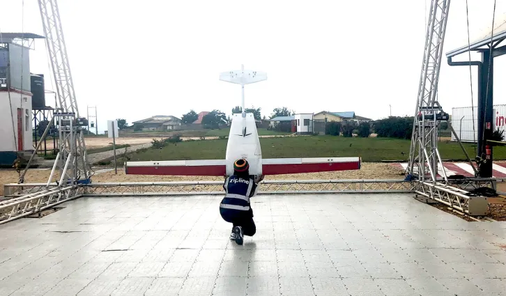 A flight operator in Rwanda recovering a Zip (Zipline’s name for the drone vehicles used to make deliveries) after returning from making a delivery at a hospital. Credit: Cj Bernstein