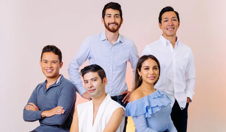 Portrait of the members of the Stanford GSB Hispanic Business Students Association on a soft pink and orange background. Photo by Elena Zhukova