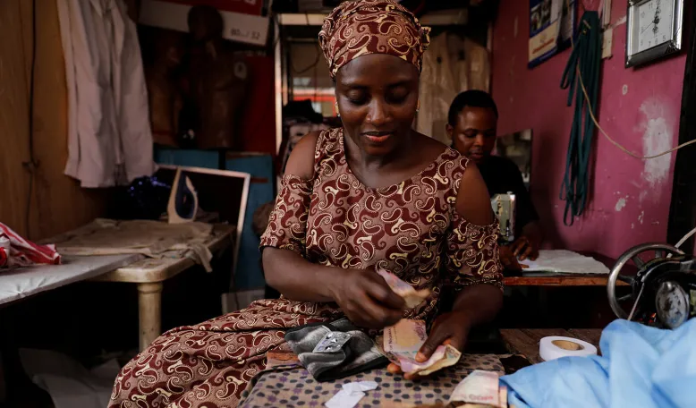 A Nigerian woman sits in a tailoring shop. Credit: Reuters/Akintunde Akinley