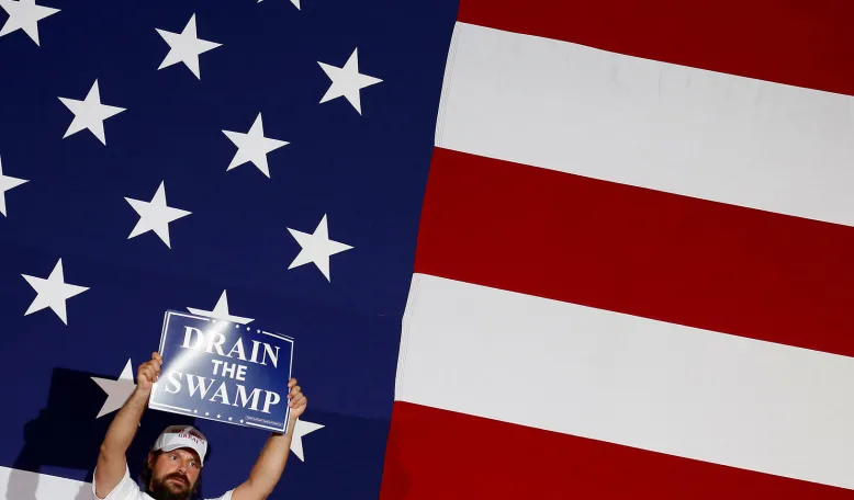 A supporter of U.S. President Donald Trump holds a "Drain the Swamp" sign. Credit: Reuters/Joshua Roberts