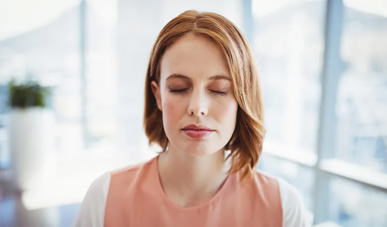 A woman takes a moment to pause and practice mindfulness  | iStock/Wavebreakmedia