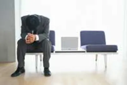 A man in a suit hanging his head in shame