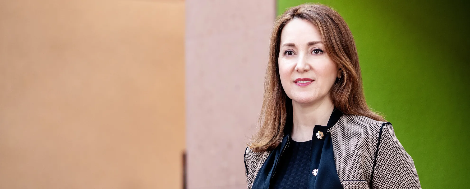 Noosheen Hashemi standing outdoors smiling, looking off camera. Credit: Winni Wintermeyer