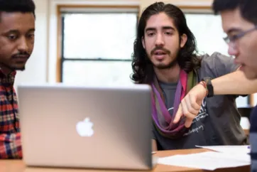 Students sitting around a computer