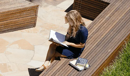 Woman reading on Stanford GSB campus