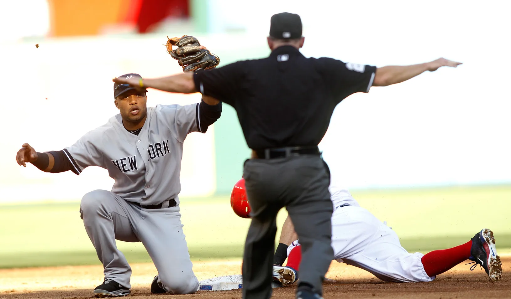 Yankees second baseman Robinson Cano looks to the umpire for the call as Texas Rangers Ian Kinsler steals second base, 2013 (Reuters photo by Mike Stone)