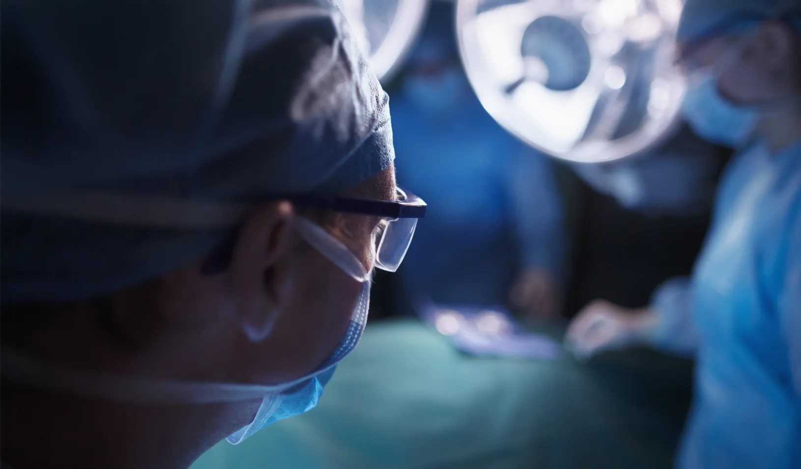 Doctors in hospital operating room stock photo. Credit: iStock/FangXiaNuo