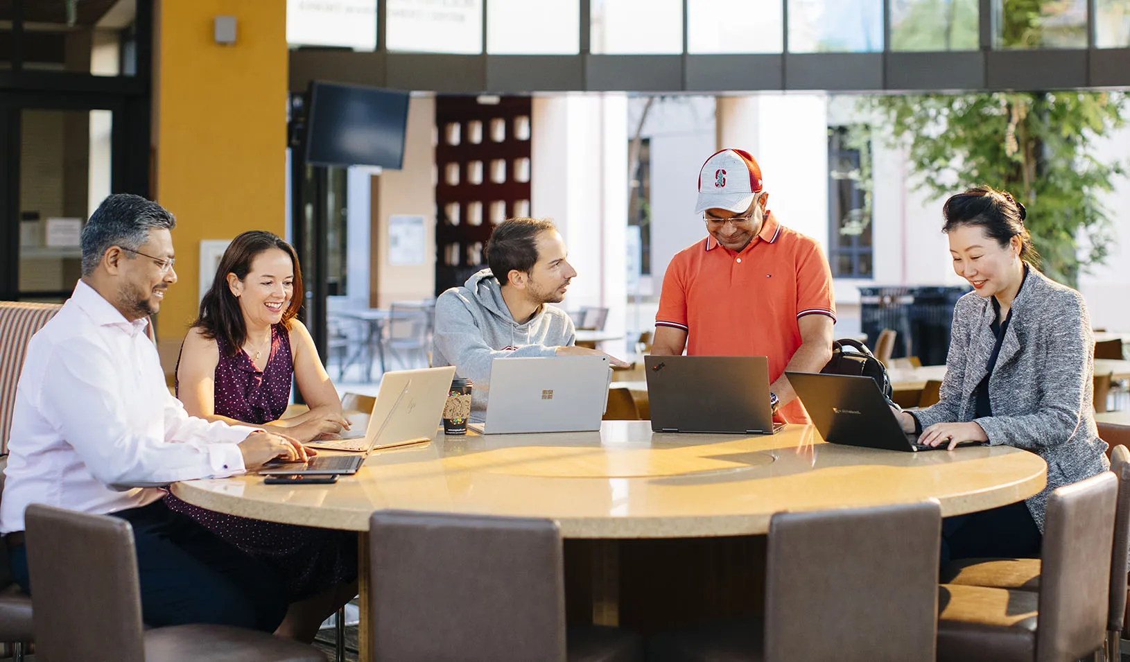 New students laughing and smiling around a table in Arbuckle dining hall. Credit: Elena Zhukova
